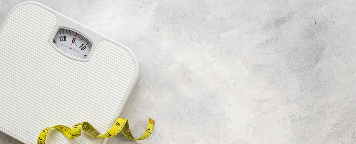 A person stepping onto bathroom scales at home